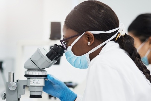 Woman looking into a microscope