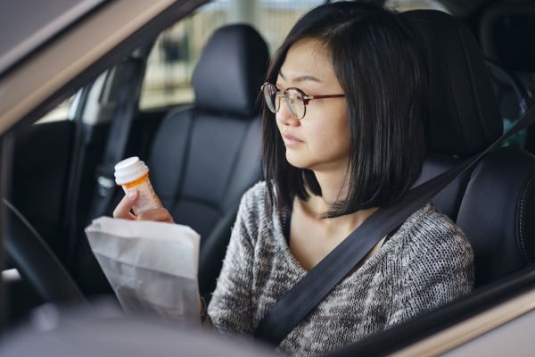 Woman at drive-through pharmacy.